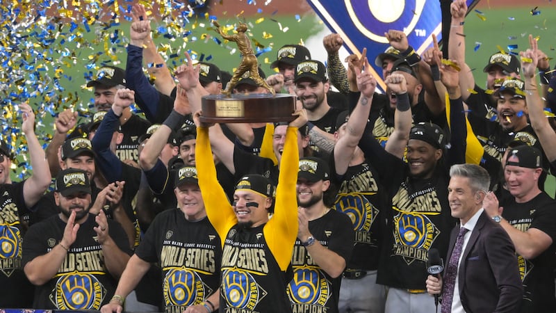 Milwaukee Brewers catcher William Contreras holds the MVP trophy after they won baseball's...