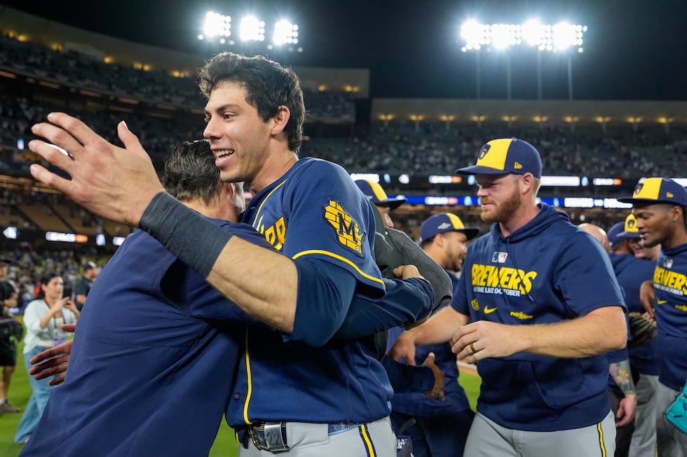Milwaukee Brewers designated hitter Christian Yelich celebrates with teammates after Game 4 of...