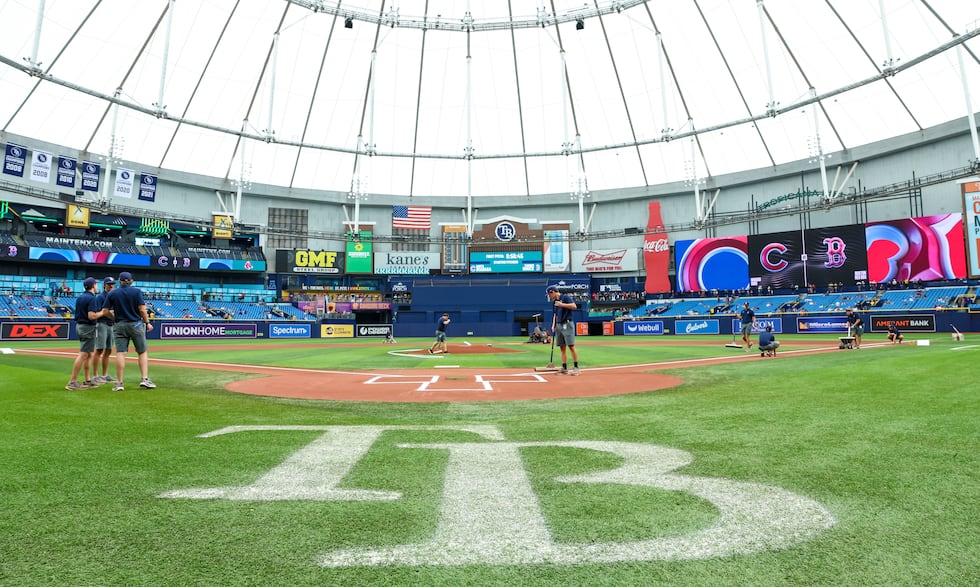 Crews prepare the field for a baseball game between the Chicago Cubs and the Boston Red Sox at...