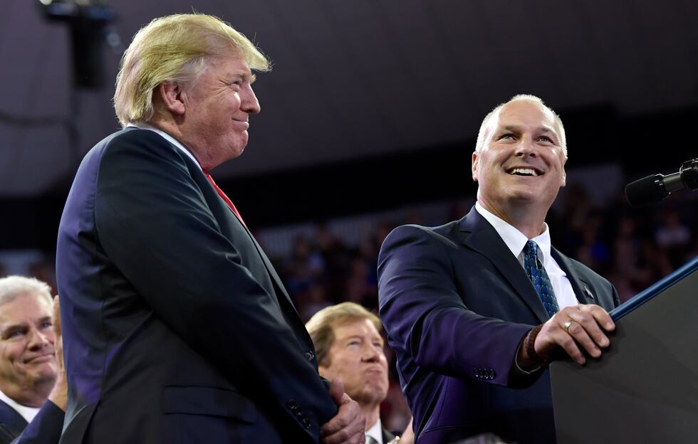 President Donald Trump gives a thumbs as he shares the stage with Pete Stauber, right, a...